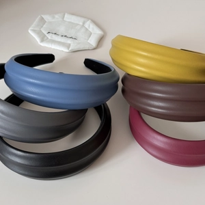 Detail of multi-color PU leather padded headbands showing premium texture and design