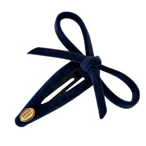 Classic navy velvet bow hair clip with gold Smile Happy plate on white background
