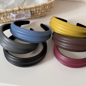 Detailed stack of six textured PU leather padded headbands in various elegant colors