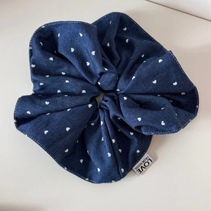 Close-up of blue denim heart pattern hair scrunchie with Love from Seoul woven label
