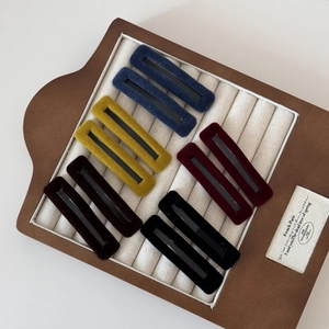 Set of 10 rectangular velvet BB hair clips in five vintage colors on a display board