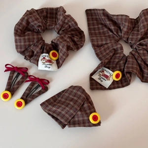 Plaid hair accessories set with brown checkered scrunchies and red bow hair clips