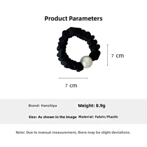 Detail view of 7cm black satin scrunchie with a large white pearl bead and size dimensions