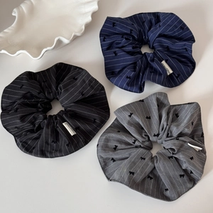 Three-piece striped hair scrunchie set in black, navy, and grey with bow patterns