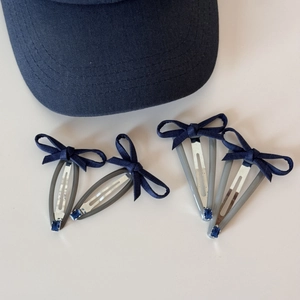 Set of four navy blue ribbon bow hair clips with small blue rhinestones and duckbill clips