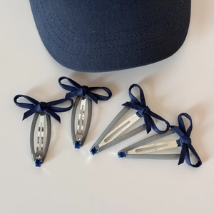 Navy blue denim bow hair clips with blue rhinestone accents for women in a 4-piece set