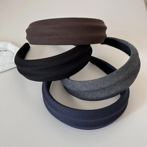 Detail of wide knitted headbands showing ribbed texture and black anti-slip lining detail