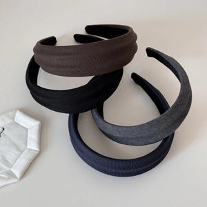 Detail showing four ribbed knit wide headbands in brown, grey, navy, and black colors