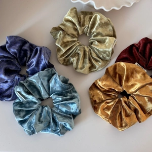 Five-piece velvet scrunchie set in assorted colors with delicate gold stars and silk texture