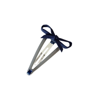 Denim bow hair clip with blue rhinestone embellishment and sleek grey base for women