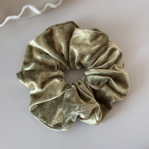 Detail of moss green velvet scrunchie with pink polka dots and soft pleated texture
