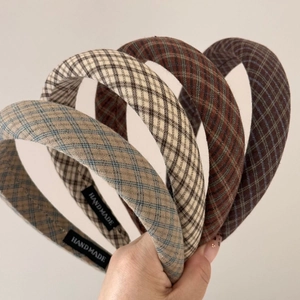 Detail shot of vintage plaid headbands showing handmade labels and fabric texture