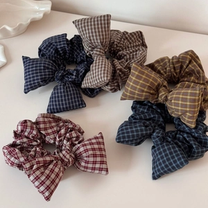 Detail showing five plaid bow scrunchies in navy, brown, yellow, grey and burgundy colors