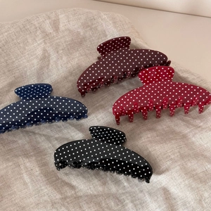 Vintage polka dot hair claws in navy, burgundy, red, and black on linen fabric