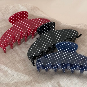 Polished scalloped hair claws with white polka dots in red, black and navy blue colors