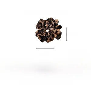 Detailed view of large leopard print scrunchie showing 15cm diameter size and fabric texture