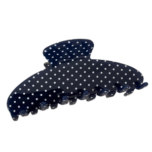Navy blue fan-shaped hair claw with white polka dots on a minimalist acrylic clip