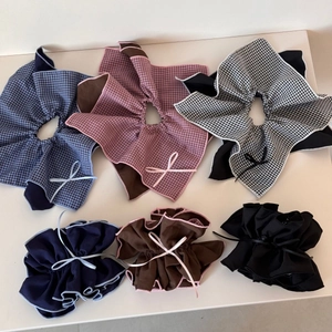 Detail view of retro plaid scrunchies with delicate ribbon bows in three colors