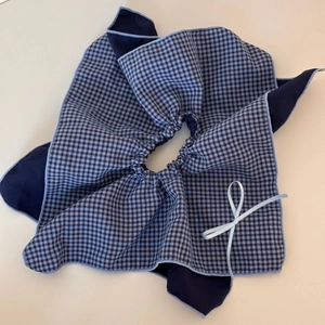Detailed view of oversized vintage plaid hair scrunchie with blue lining and bow knot