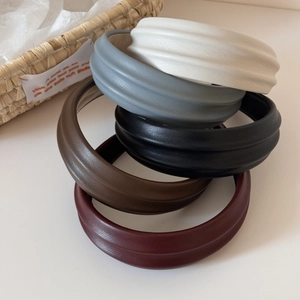 Close-up of vintage PU leather headbands with horizontal embossing and foam padding