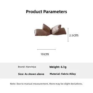 Detail view of coffee fabric bow clip with 10cm x 2.5cm size and 6.1g weight parameters