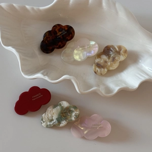 Macro detail of cloud shaped acetic acid mini hair clips in various elegant patterns