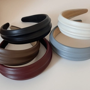 Detailed stack of multi-colored textured PU leather headbands with pleated design