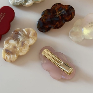 Detailed close-up of cloud-shaped acetate hair clips with France Handmade text logo