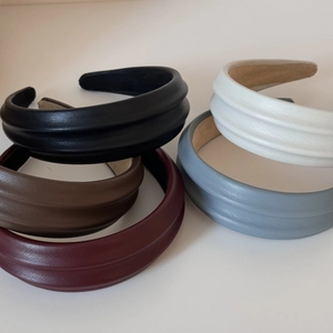 Macro view of textured PU leather padded headbands in five classic colors for women