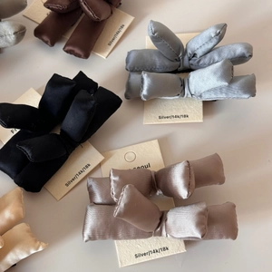 Chic satin padded bow hair clips in assorted colors on premium display card