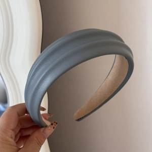 Detail view of the Morandi blue-grey PU leather headband with thick double-ridge texture