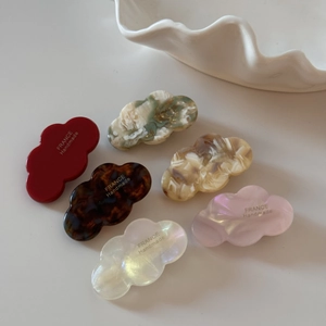 Set of 6 colorful acetate wavy hair clips in a ceramic bowl with elegant minimalist styling