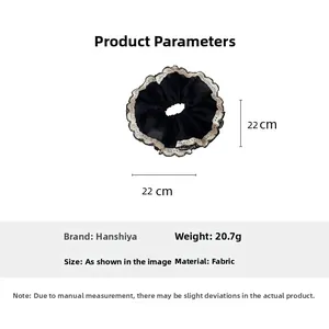 Detail view of large black pleated hair scrunchie with white lace trim and 22cm diameter size