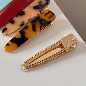Close-up of handmade acetate hair clips with tortoiseshell pattern and metal duckbill base