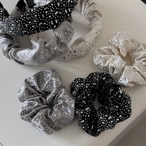 Close-up of velvet hair scrunchies and headbands set with sparkling rhinestones