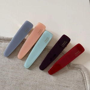 Detail view of five acetate duckbill hair clips with France Handmade gold lettering