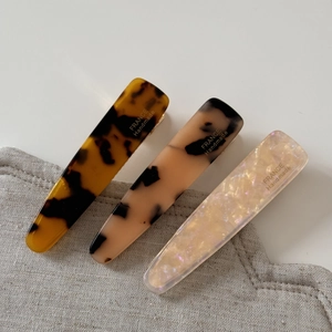 Detailed view of handmade acetate hair clips in tortoise shell and marble textures