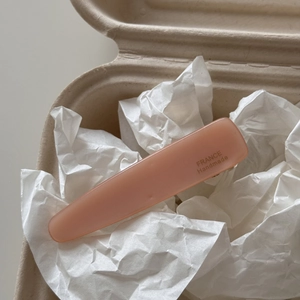 Detail of a matte pink acetate hair clip with golden France Handmade engraving