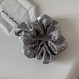 Close-up of velvet hair scrunchie with rhinestones and crystal beads for women