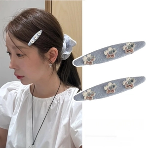 Minimalist denim blue floral hair clips for women shown on model and in white background