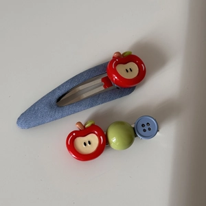 Detail view of denim blue BB clip with red apple and beaded hair pin accessory set