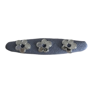 Denim blue hair clip with three silver flower metal accents on a minimalist barrette