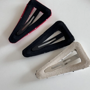 Detail view of the metal snap clips and fabric backing on triangle BB hairpins set