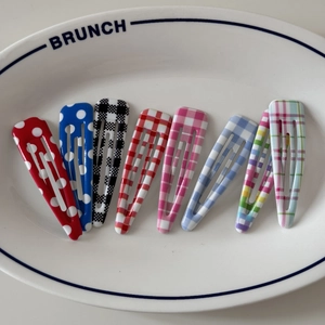 Close-up of 8-piece hair clip set with colorful polka dots, plaid, and rainbow stripes