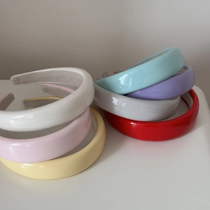 Glossy candy-colored sponge headbands in various bright patent leather finishes