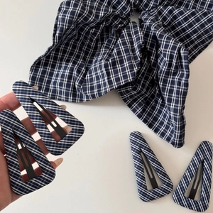 Navy blue plaid triangle hair clip and matching scrunchie set on white background