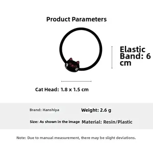 Detailed view of a black elastic hair tie featuring a cute resin cartoon cat head charm