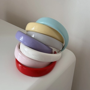 Close-up of colorful patent leather padded headbands in a variety of vibrant candy colors