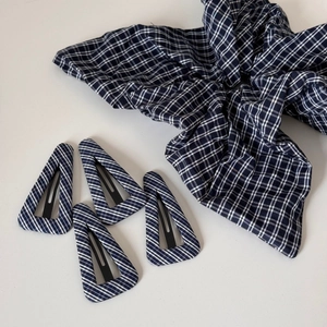 Detail showing navy plaid checkered hair scrunchie and four matching BB hair clips