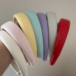 Vibrant candy colored sponge headbands in glossy patent leather for a high cranium fashion look